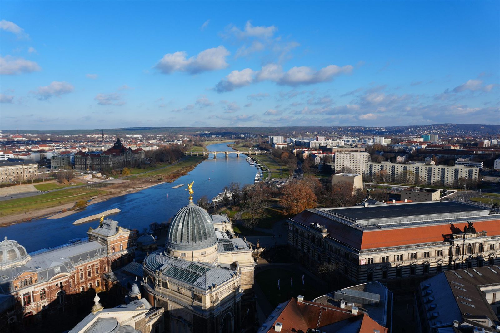 Aerial view of the Elbe curving past Dresden with wide green meadows along both banks