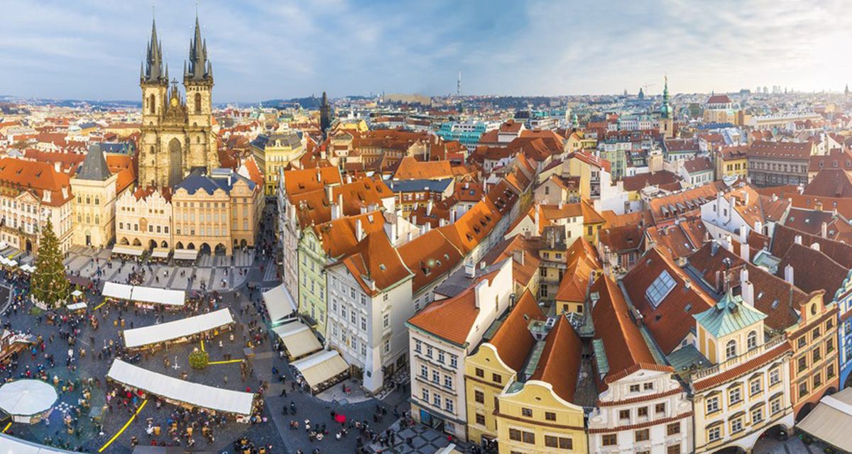 Red rooftops of Prague Old Town and the twin Gothic towers of the Týn Church, the end point of an Elbe river cruise from Berlin to Prague